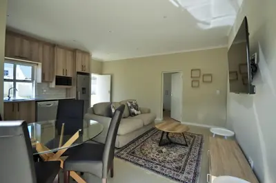 a living room with a couch and a table at Tweespruit Estate - Stellenbosch- 3 Bedroom House in Stellenbosch