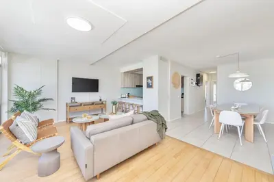 a living room with a couch and a table at Beautiful & Modern Dolphin Beach CG12 by HMH in Cape Town