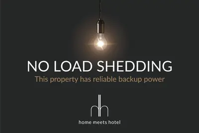 a sign that says no load shedding with a light at Beautiful & Modern Dolphin Beach CG12 by HMH in Cape Town