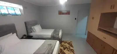 a hotel room with two beds and a television at RoomIsGood in Cape Town