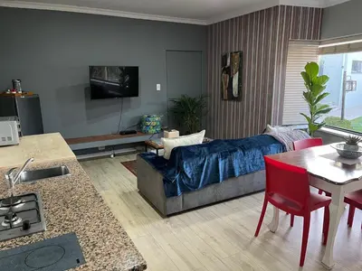 a living room with a couch and a table at Queens Corner in Wellington