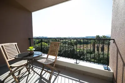 a balcony with a table and chairs and a view at Family Suite-Two Bedroom Waters Edge in Cape Town