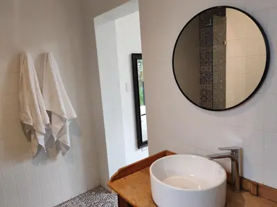a bathroom with a white sink and a mirror at Your Quiet Retreat Near Cape Town & Wine Country in Hoheizen
