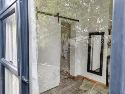 a glass door of a shower with a mirror at Your Quiet Retreat Near Cape Town & Wine Country in Hoheizen