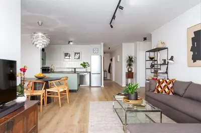 a living room with a couch and a table at Luxurious Palm View Apartment Cape Town in Cape Town