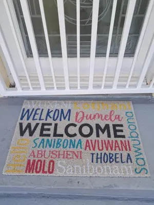 a welcome sign on the front of a building at Deo Volente Self-Catering Cottage in Kuilsrivier