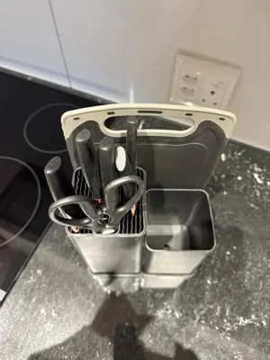a container filled with utensils sitting on a counter at Luxe 1br apartment on Park in Cape Town