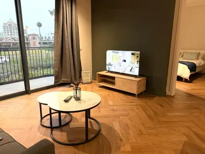 a living room with a tv and a table at Luxe 1br apartment on Park in Cape Town