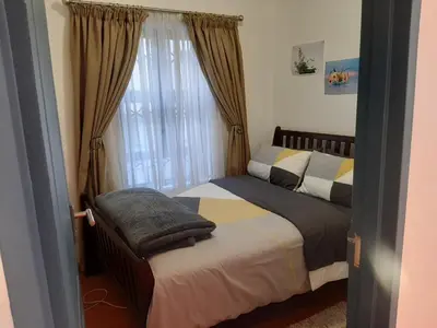 a bedroom with two beds and a window at Local & Comfortable in Mandalay