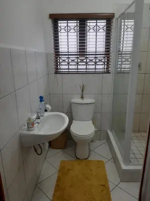 a bathroom with a toilet and a sink at Local & Comfortable in Mandalay