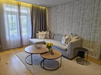 a living room with a couch and two tables at Winelands Golf Lodges 34 at De Zalze in Cape Town