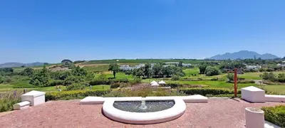 a fountain sitting on top of a red brick yard at Winelands Golf Lodges 34 at De Zalze in Cape Town