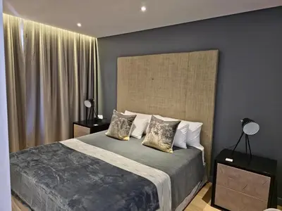 a bedroom with a large bed with two pillows at Winelands Golf Lodges 34 at De Zalze in Cape Town
