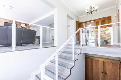 a staircase in a home with white walls and white stair case at Akasia 1 in Caledon