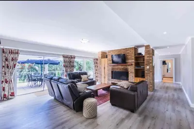 a living room with two couches and a fireplace at Akasia 1 in Caledon