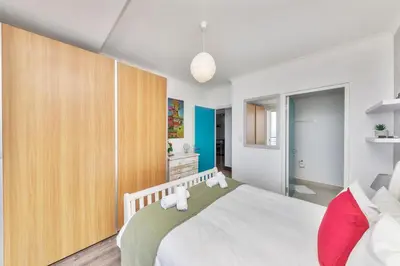 a bedroom with a large bed with two teddy bears on it at Horizon Bay 201-Beachfront Gem Table Mtn in Cape Town