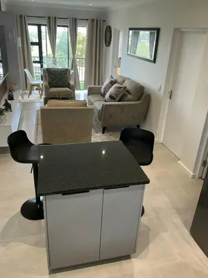 a living room with a couch and a table at DRJ Luxe in Cape Town
