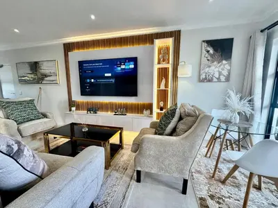 a living room with a large flat screen tv at DRJ Luxe in Cape Town
