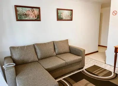 a living room with a couch and two pictures on the wall at 4 Jooste Street in Windsor Park