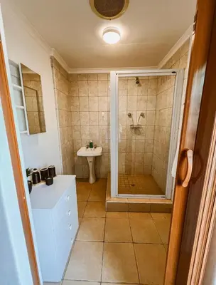 a bathroom with a shower and a sink at 4 Jooste Street in Windsor Park