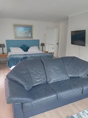 a living room with a couch and a bed at Mountain View in Hermanus