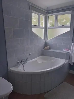 a bath tub in a bathroom with a window at Mountain View in Hermanus