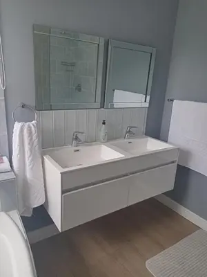 a bathroom with a white sink and a mirror at Mountain View in Hermanus