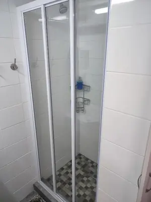 a shower with a glass door in a bathroom at Birds Holiday Accommodation 1 in Zeekoevlei