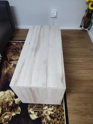 a wooden coffee table sitting on top of a rug at Birds Holiday Accommodation 1 in Zeekoevlei