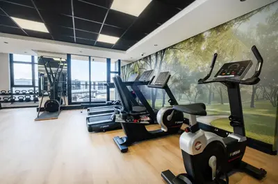 a gym with cardio machines and a mural at 507 Riverlands - Lux Studio Apartment in Cape Town