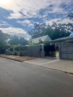 a house with a fence on the side of a street at Conde Rest in Stellenbosch