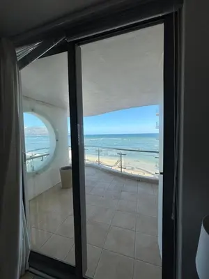 a view of the beach from a room with a sliding glass door at A little heaven in Strand