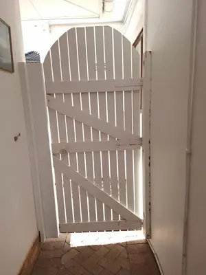 a white gate in a hallway with a door at 28 on Old Farm in Cape Town