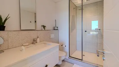 a bathroom with a shower and a sink and a toilet at Bridgewater Serenity Collection 708 in Cape Town