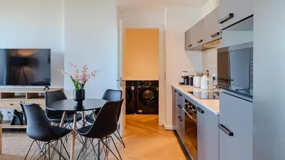 a kitchen with a table and chairs in a room at Bridgewater Serenity Collection 708 in Cape Town