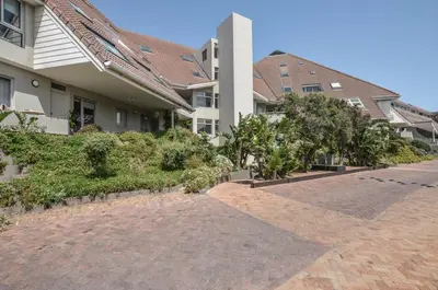 a brick driveway in front of a house at 2 Bedroom Apartment - Dolphin Beach in Cape Town