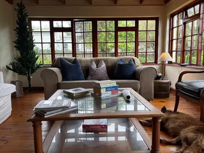 a living room with a couch and a coffee table at Hermanus Hartshuis in Hermanus