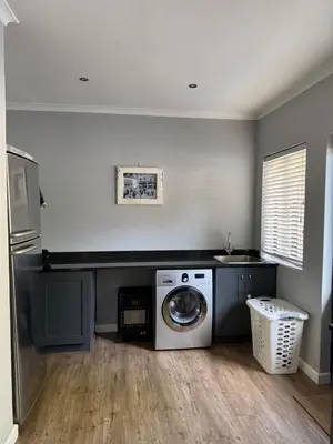 a washing machine in a kitchen with a sink at 10onErika Franschhoek in Franschhoek