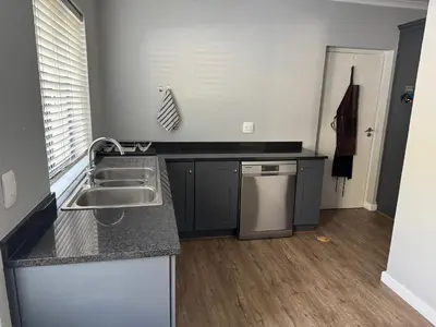 a kitchen with a sink and a counter top at 10onErika Franschhoek in Franschhoek