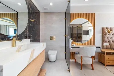 a bathroom with a sink and a toilet and a mirror at Lagoon Beach Luxe 116A in Cape Town