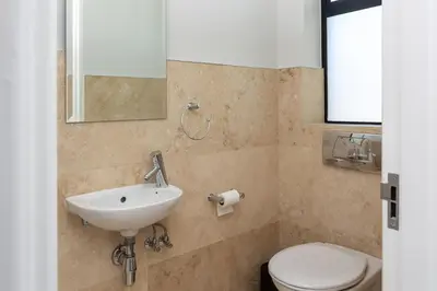 a bathroom with a sink and a toilet at Luxury Lodge TheView, Pearl Valley Golf Estate in Paarl