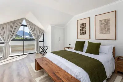 a bedroom with a large bed and a large window at Luxury Lodge TheView, Pearl Valley Golf Estate in Paarl