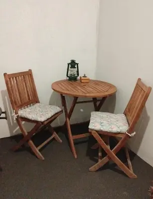 a table and two chairs with a lamp on it at Heaven Scent in Bettyʼs Bay