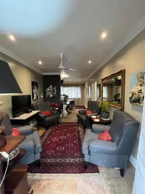 a living room with couches chairs and a television at Somerset West All Stay 4 in Somerset West
