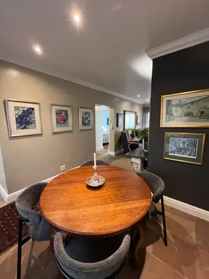 a dining room with a wooden table and chairs at Somerset West All Stay 4 in Somerset West