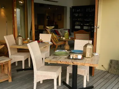 a table with chairs and a table with a plate on it at 43 On Sandstone in Somerset West