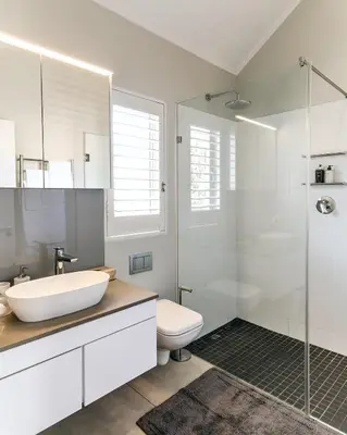 a white bathroom with a sink and a shower at Luxury Villa in Best Central Location in Franschhoek