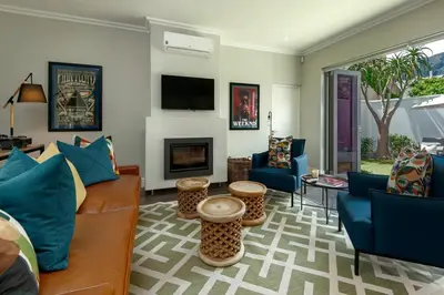 a living room with a couch and chairs and a fireplace at Luxury Villa in Best Central Location in Franschhoek