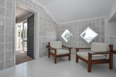 a room with two chairs and a table and windows at Large 4 Bedroom Villa with Pool in Cape Town