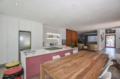 a large kitchen with a wooden table in a room at Large 4 Bedroom Villa with Pool in Cape Town
